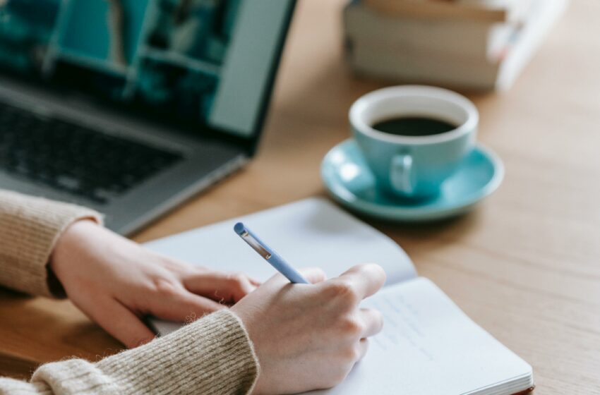 woman proofreading an article on paper