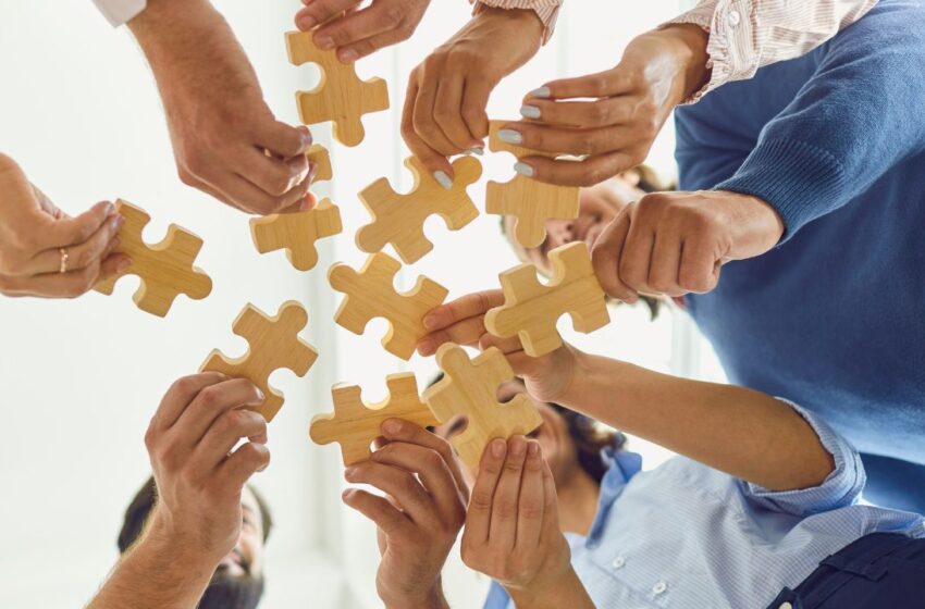 Graphical abstracts can bridge the gap between complex data and readers. The image shows people putting together puzzle pieces to represent this idea.