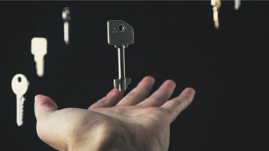 Hand holding a key representing open access publication.