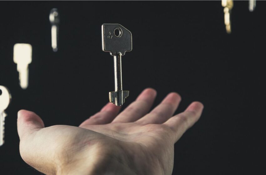 Hand holding a key representing open access publication.